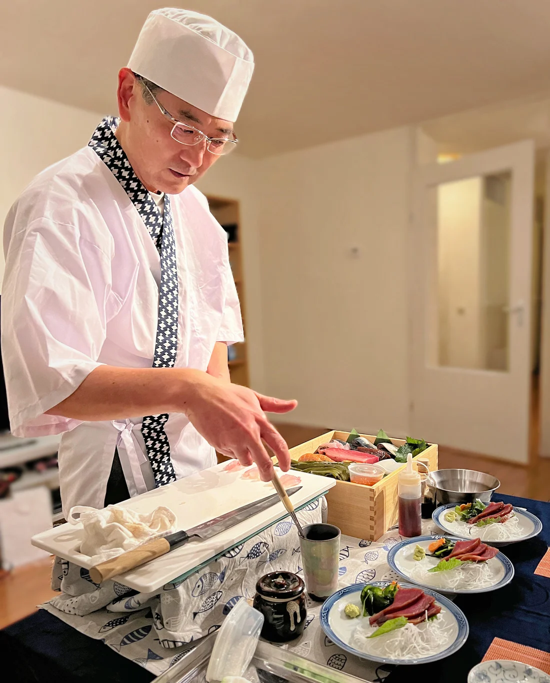Chef Norihiro preparing sushi in a home kitchen